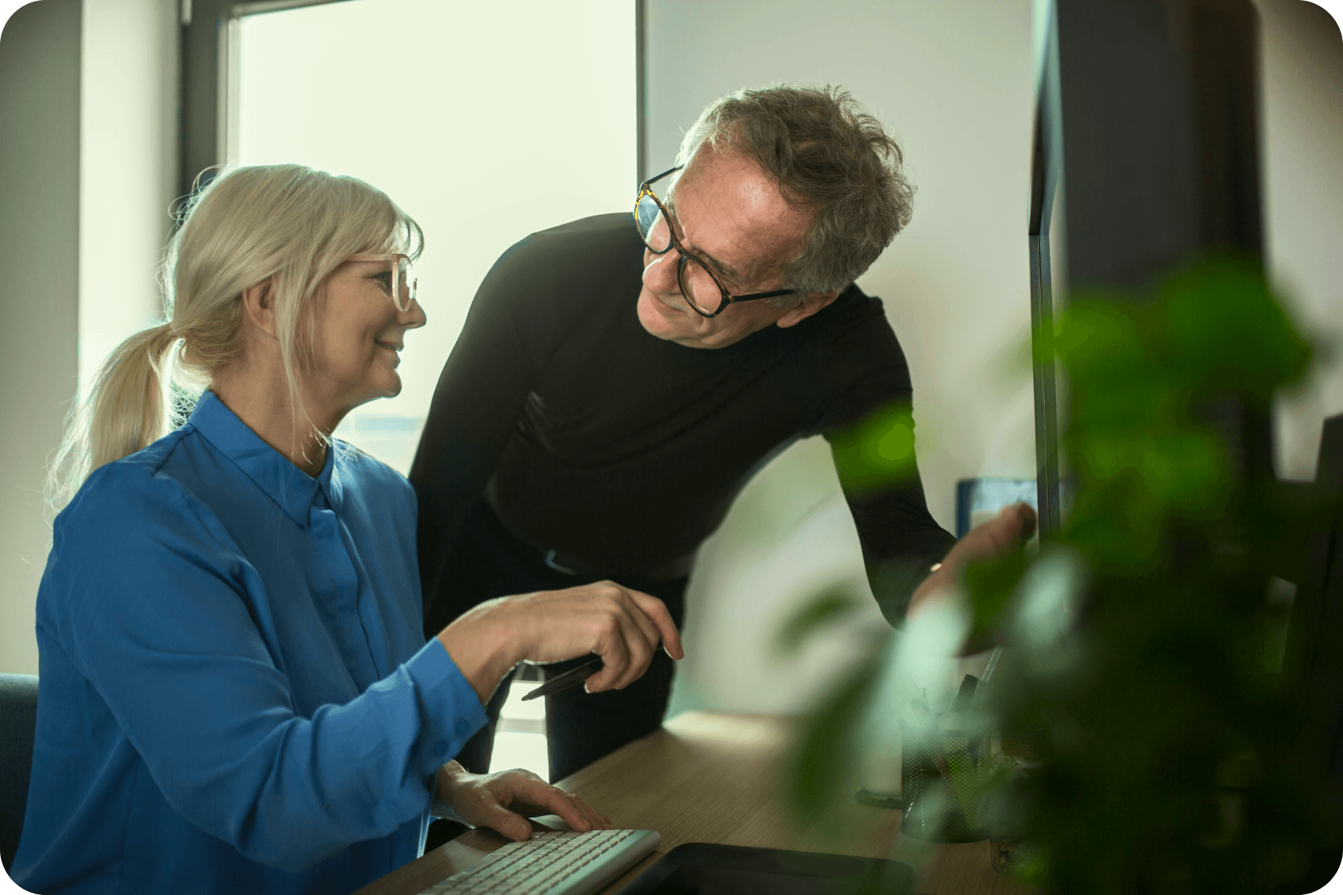 two-senior-colleagues-working-together-at-desk-in-2022-12-16-22-26-48-utc 1 (1)